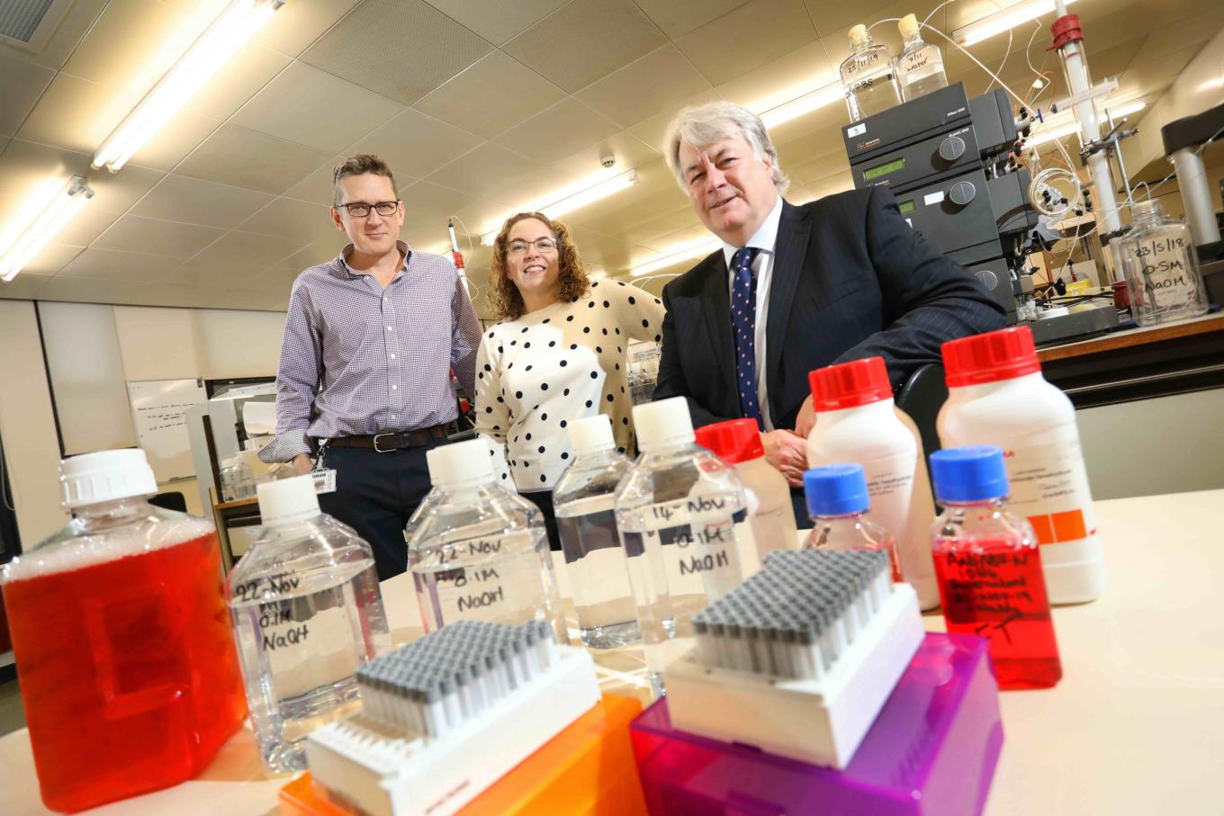 Three colleagues from Absolute Antibody standing in the lab with various technical equipment on the table