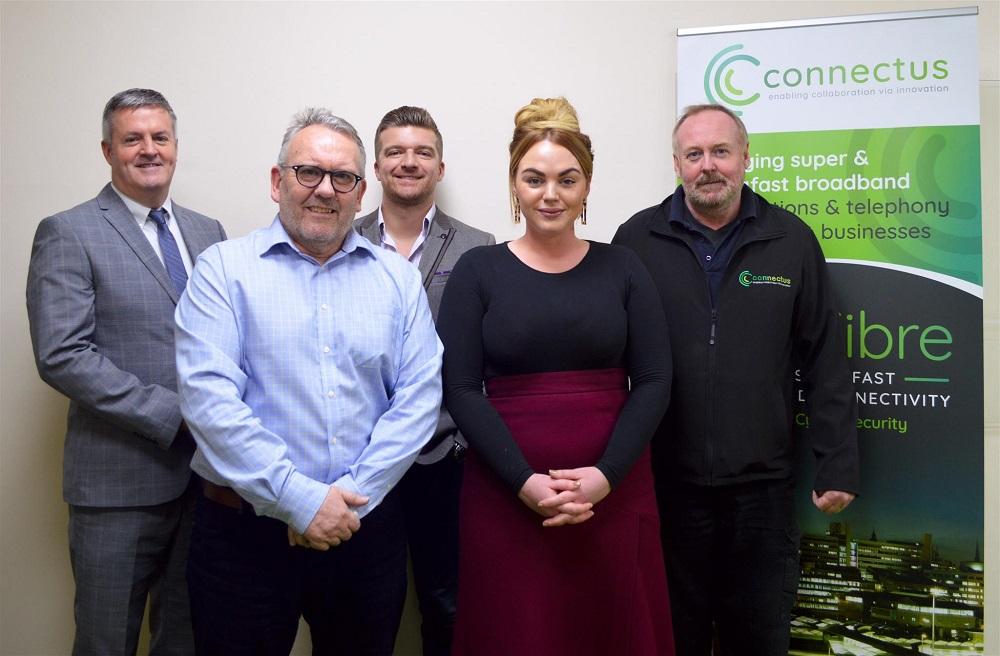 4 men and and women smiling with a Connectus pop up banner in the background