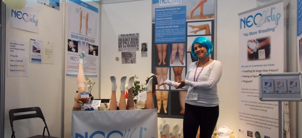 A woman from Neo-Slip in a pop up exhibition space showing her stocking products