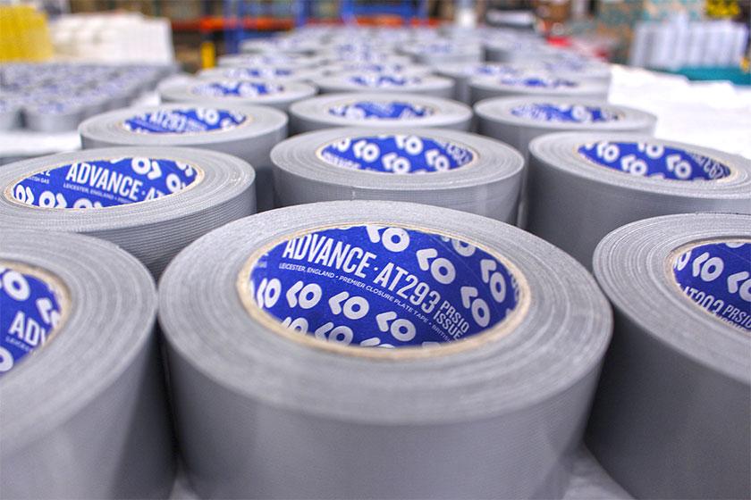 Numerous roles of duck tape lined up in a warehouse environment