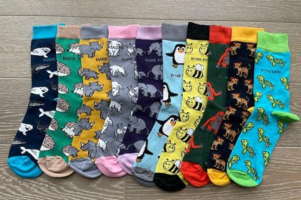 The full range of Bare Kind animal socks laid out in a row
