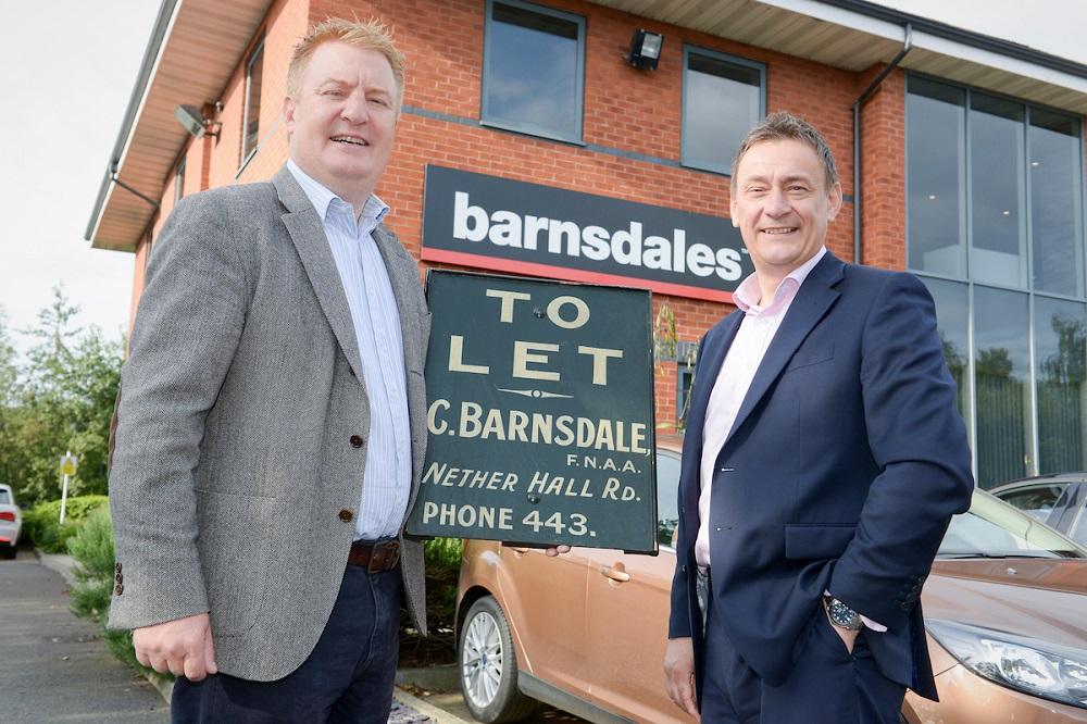 2 men stood outside of the Barnsdales office holding a To Let sign