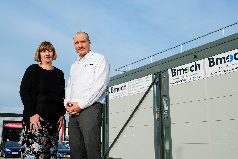 A man and a woman stood outside of the BMECH office building