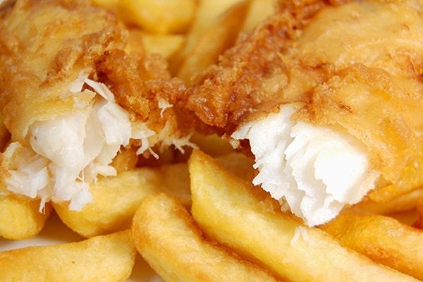 Close-up of chip shop-style battered cod and chips