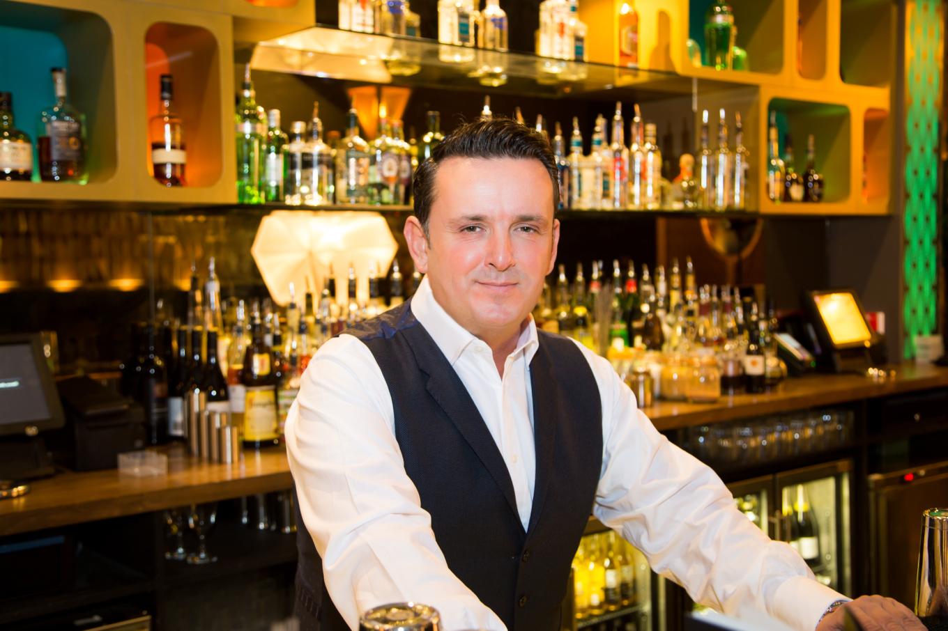 Scott Matthews, CEO of DC Bars, behind the bar in one of his premises
