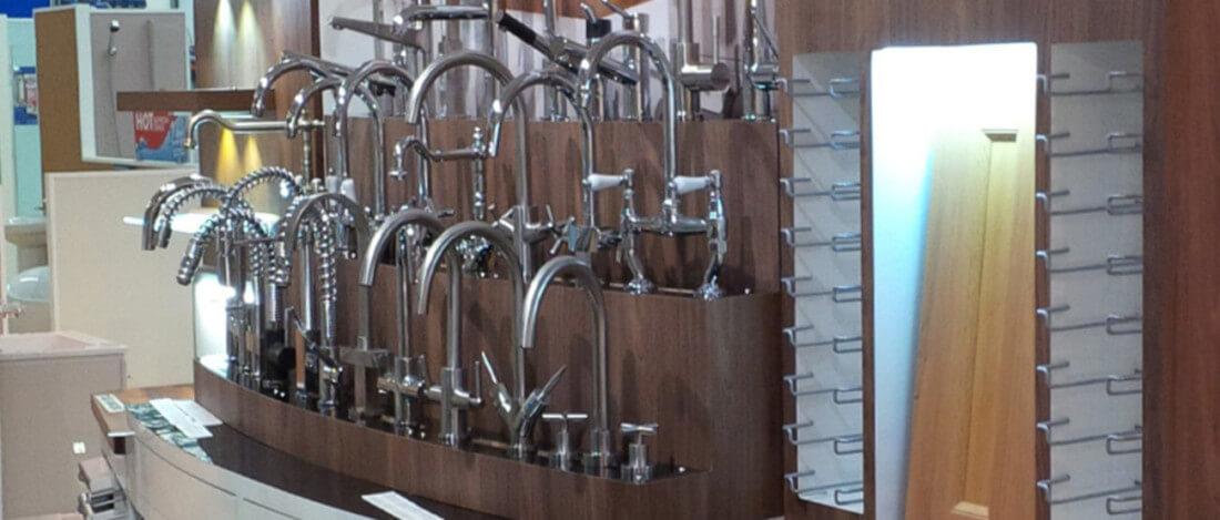 A selection of kitchen taps on display in a shop