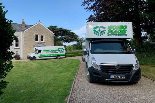 Going Places Removal vans parked outside a house in the countryside