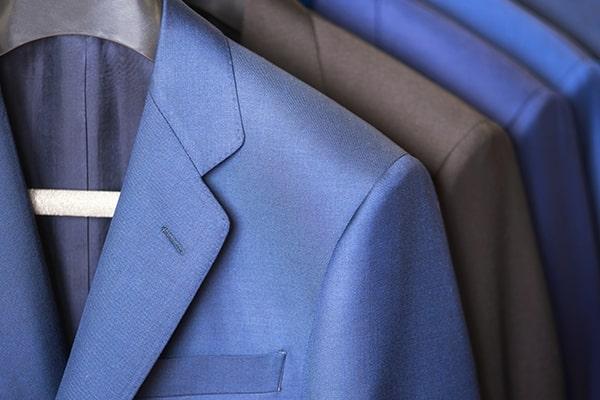 Close-up of tailored gentlemen's suits hanging on a rack