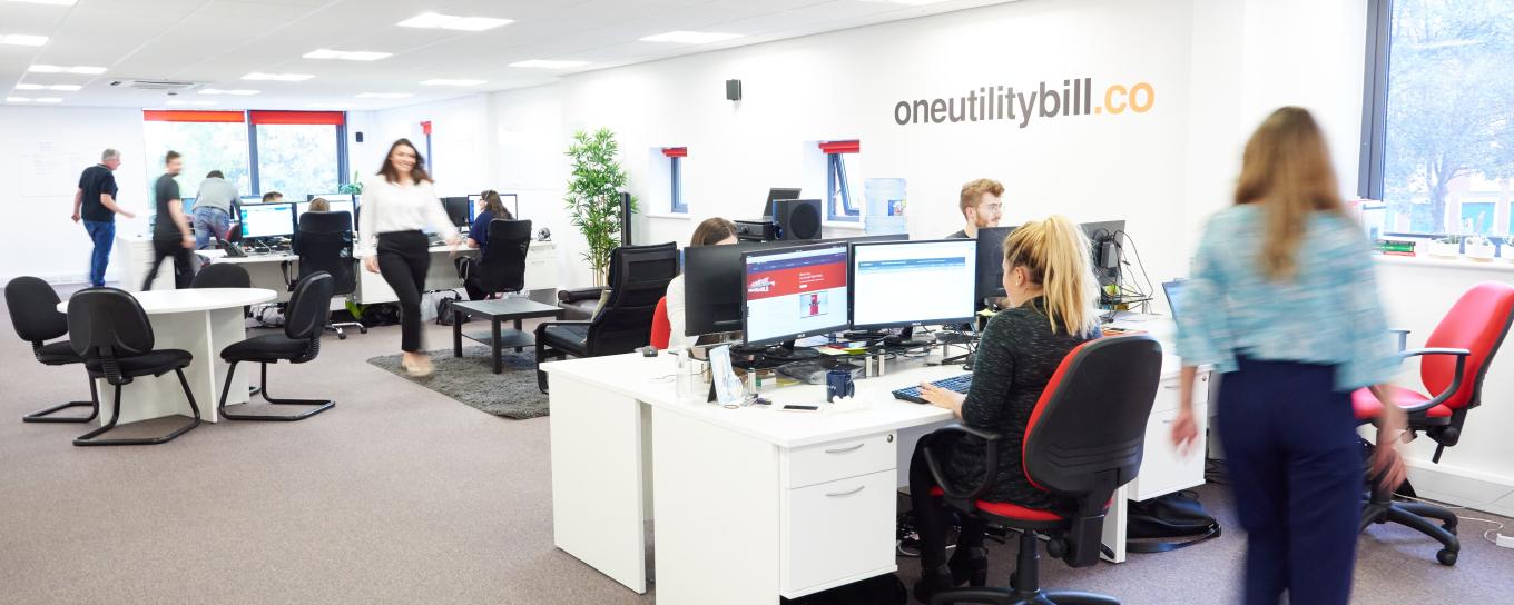 Interior of One Utility Bill's modern offices, with colleagues sitting at desk working on computers