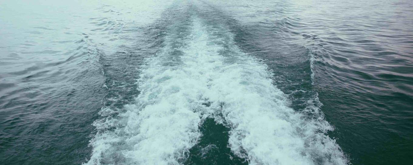 Ripples of water on a river caused by a powerboat