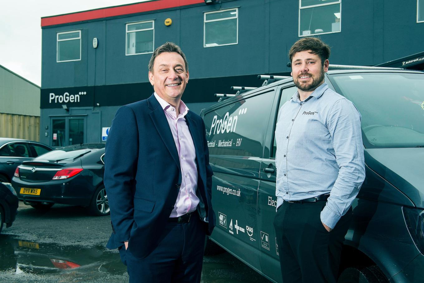 2 men stood in front of the ProGen building and a ProGen branded van