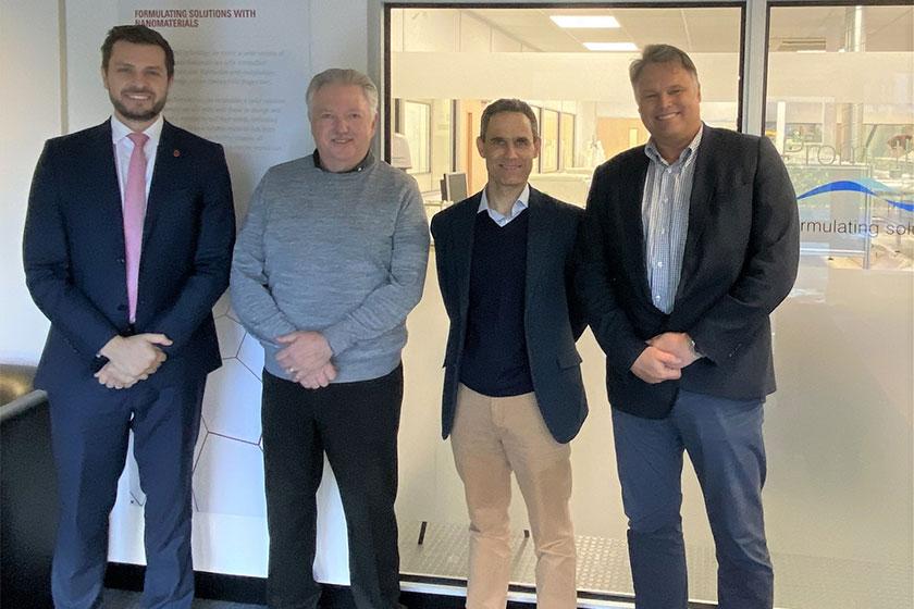 4 men smiling and stood in the Promethean Particles office