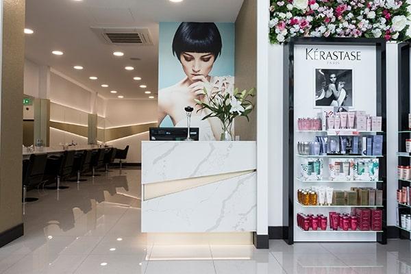 The interior of Room97's salon, showing the hairdressing chairs, reception and a display unit of hair products