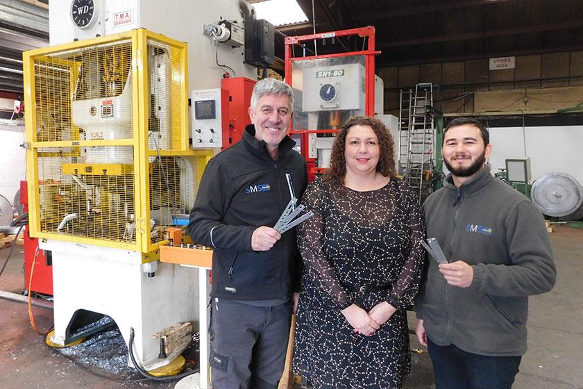 2 men and a women stood in a steel manufacturing factory