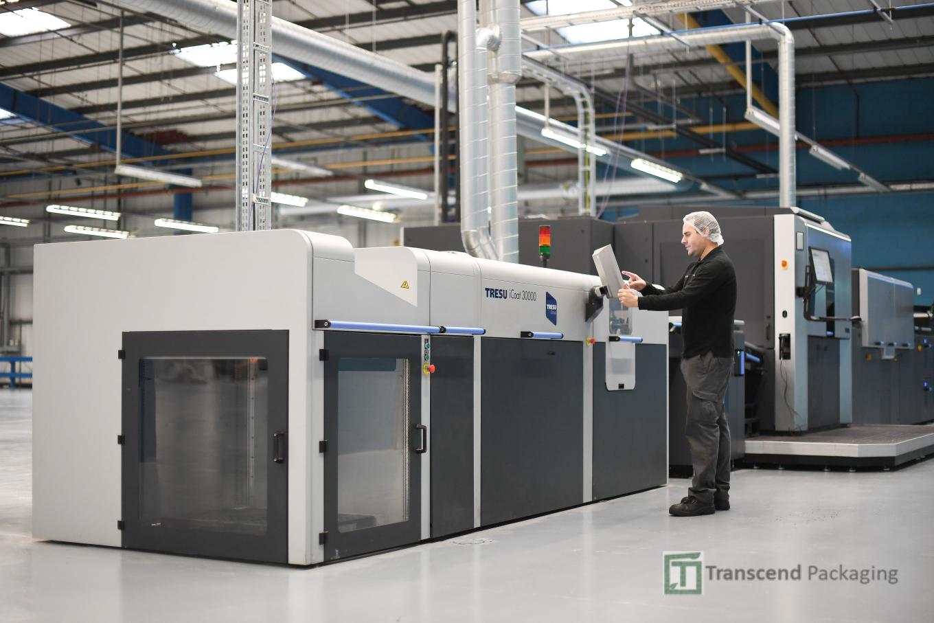 A Transcend Packaging employee using a console to set up one of its packaging machines