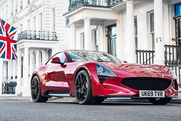 A red TVR Griffith sports car parked on an affluent-looking city street