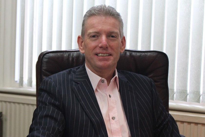 Man in a suit sat in a leather chair