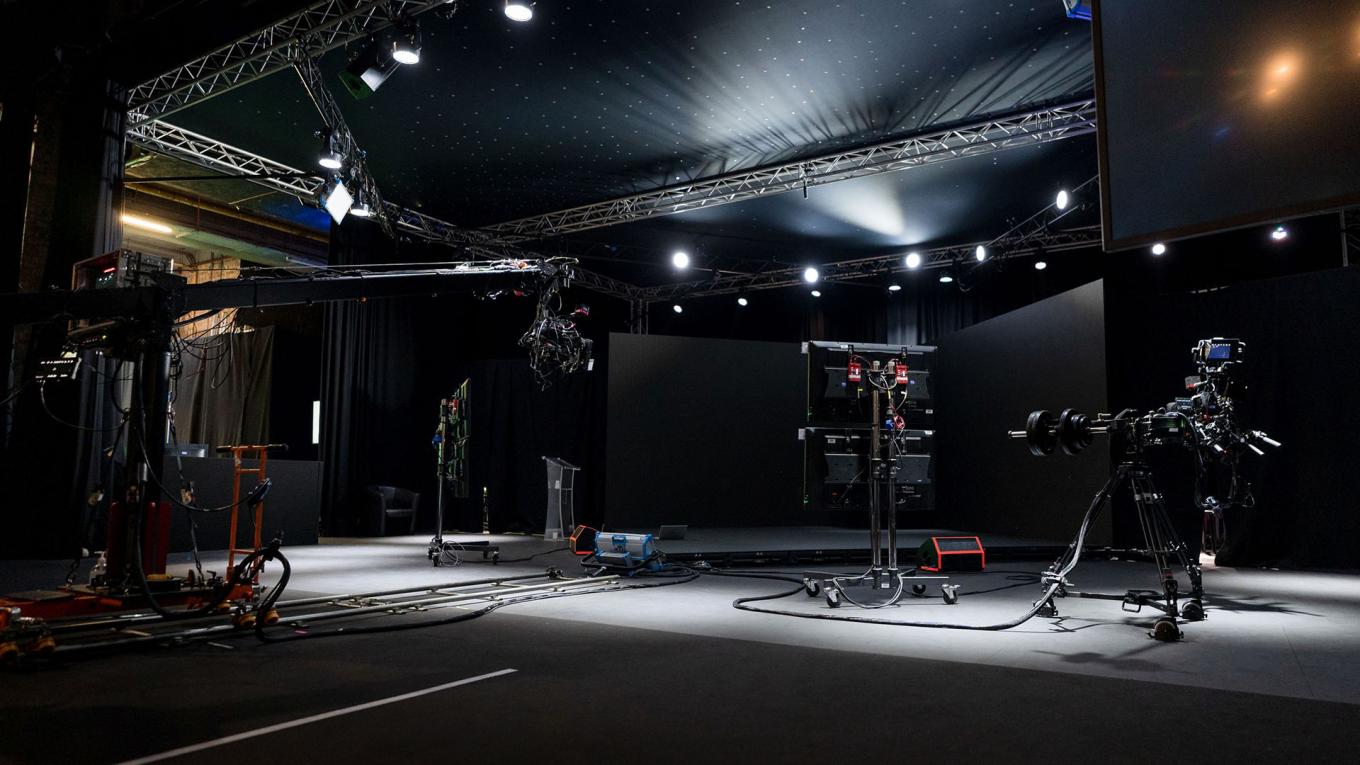 Dark TV Studio lit up with spotlights and cameras
