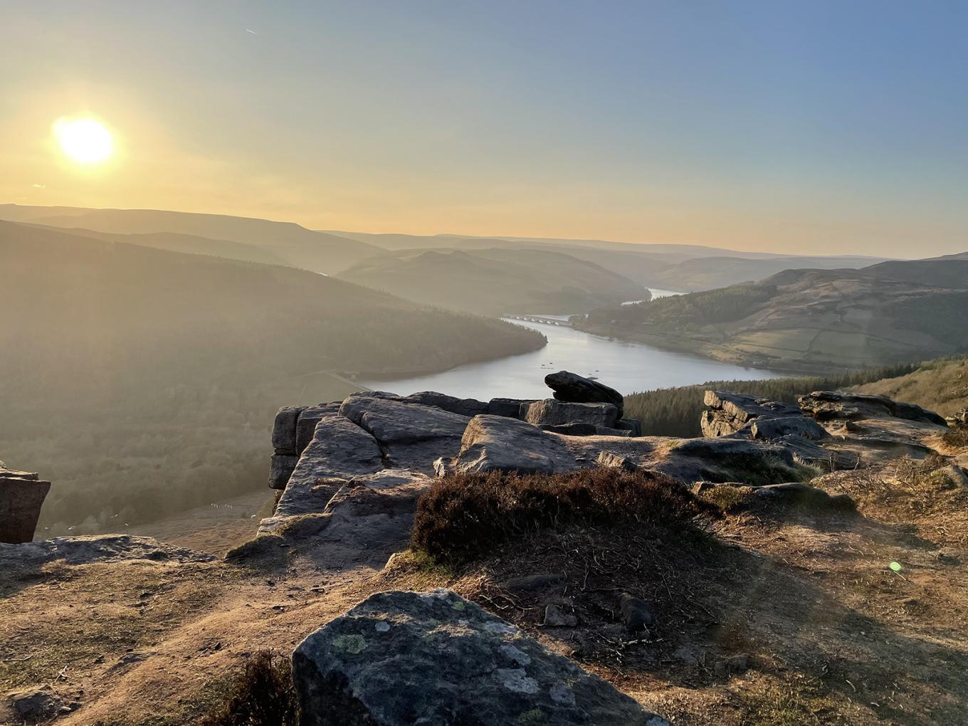 Panoramic mountain view of a lake and the sunset