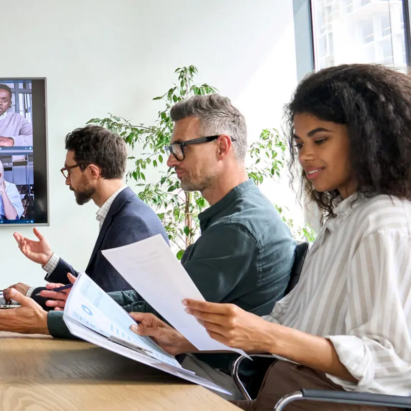 Staff sat in a boardroom reading documentation