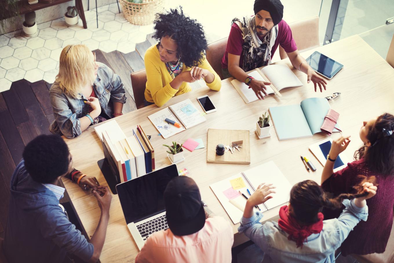 Colleagues sitting and working around a table