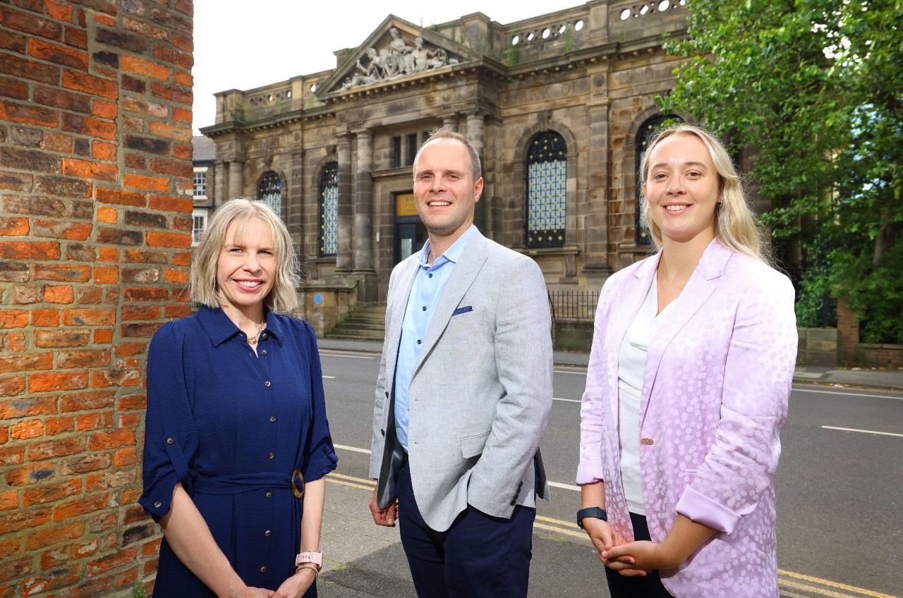 a group of people standing in front of a building