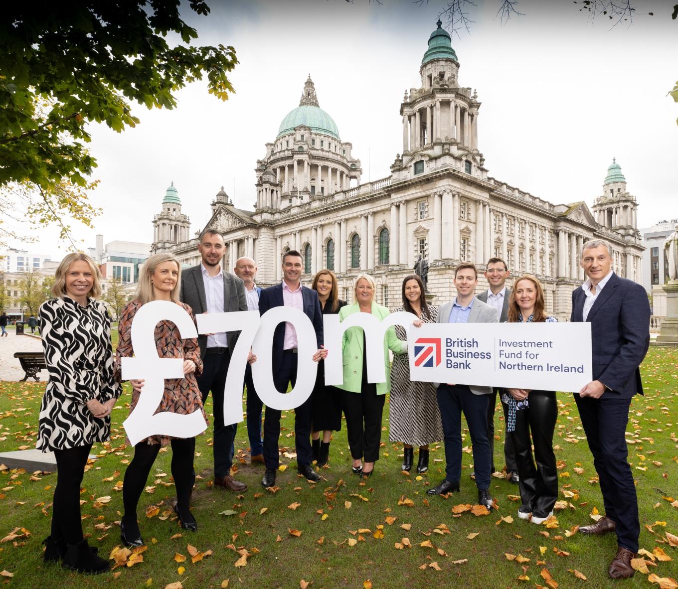 Photo of British Business Bank, Whiterock and Clarendon Fund Manager staff in Belfast holding a £70million sign and the Investment Fund for Northern Ireland logo