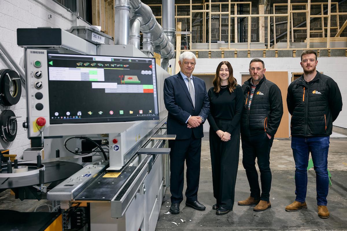 A group of people standing next to lab machine 