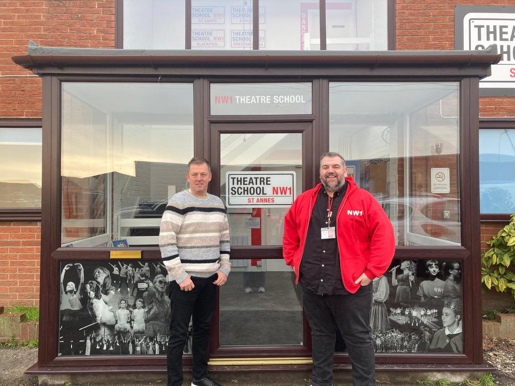 An image of two men standing in front of the theatre school