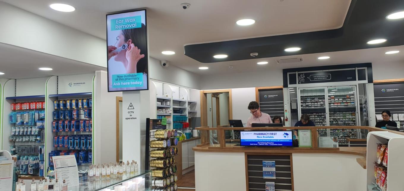Demonstration image of screen installation in a pharmacy retail environment