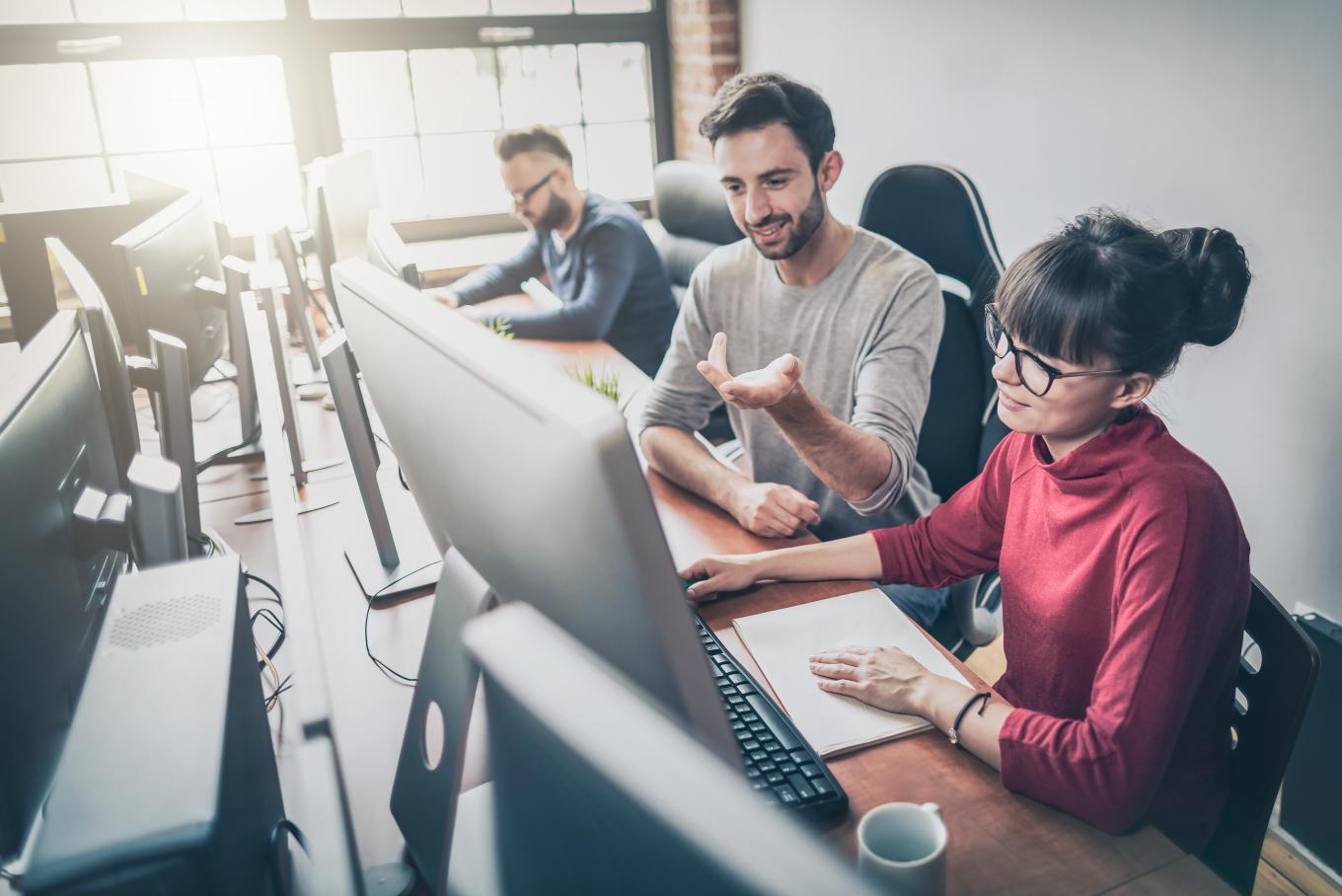 Man and woman working at a desktop