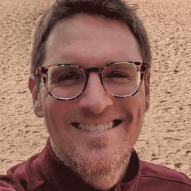 Barry McCulloch standing on sand / beach