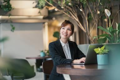 Asian woman working at a laptop